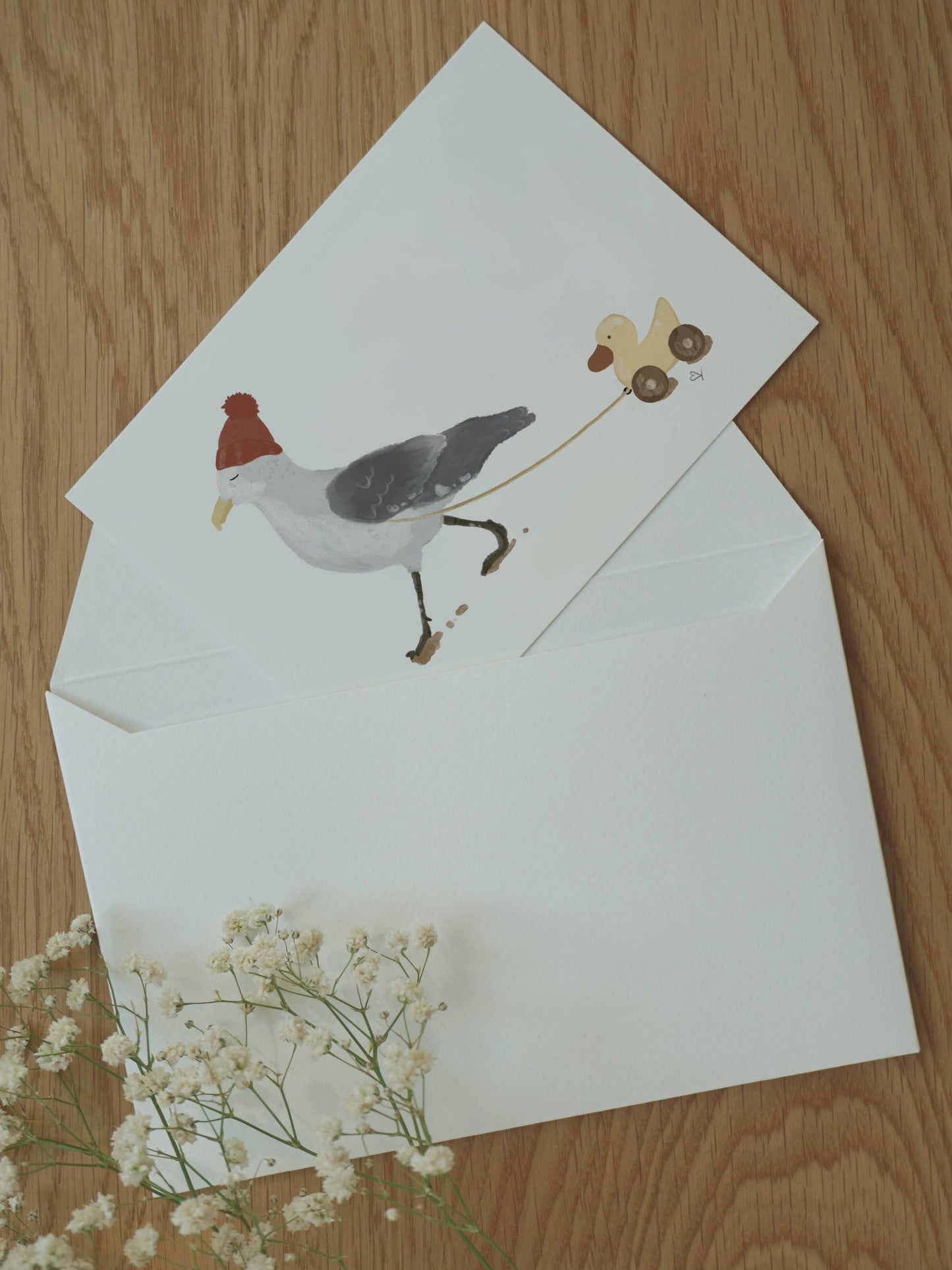 Die Postkarte Möwe spaziert mit Ente steckt halb in einem Briefumschlag A6 Format. Persönliche Aufmerksamkeit, Geschenk für Kinder, Papa, Mama, Freunde.