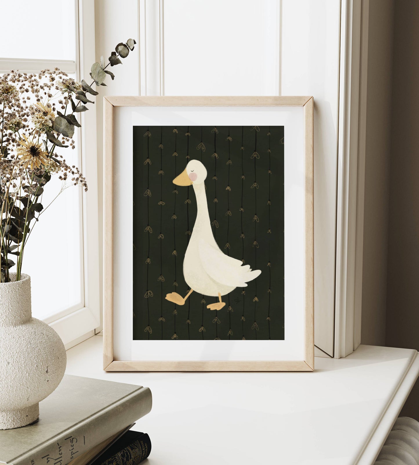 Poster Gans im Glühwürmchenregen im Rahmen auf dem Fensterbrett im gemütlichen Ambiente bei hellem Licht und Vase mit Trockenblumen dekoriert.